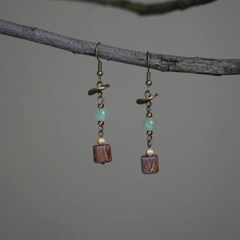 Brass earrings featuring coconut wood pendants in vintage everyday style