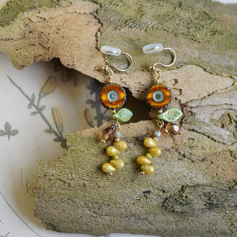 Vintage-style flower earrings feature Czech glass beads and brass hooks, adding elegance with a retro charm.