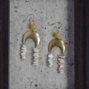 Handmade brass earrings feature natural seashell accents for a vintage coastal look