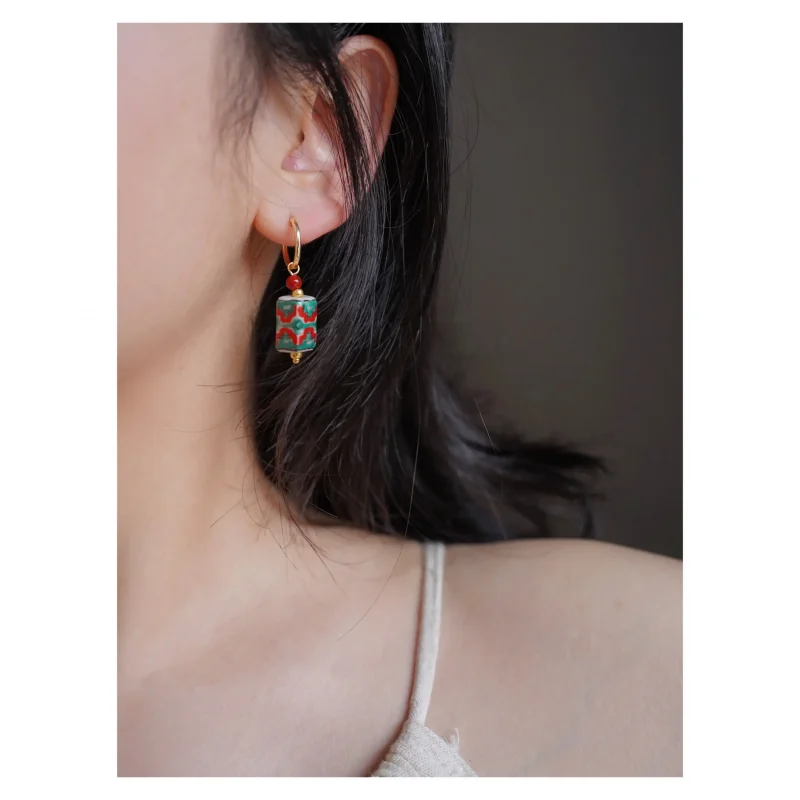 Model wears handmade ceramic bead earrings, highlighting a graceful fusion of artisanal charm and modern elegance.
