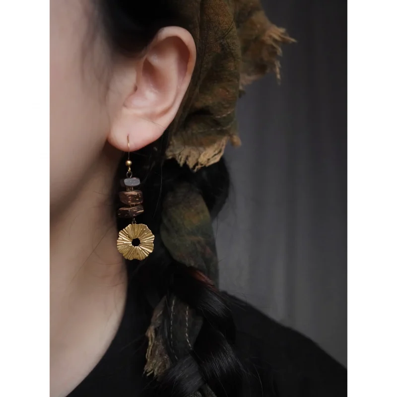 The model showcases handmade coconut wood earrings that highlight natural texture and artisanal charm.