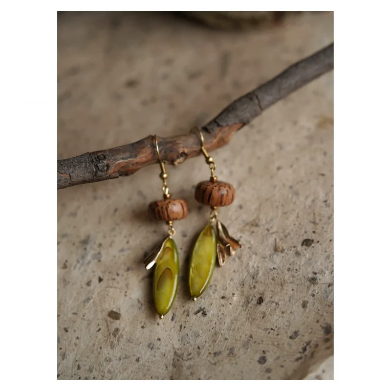 Handcrafted coconut wood earrings featuring natural Nepalese beads in a rustic boho style