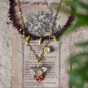 Layered handmade garnet beaded necklace shows vintage charm and natural texture with rich gemstone color.