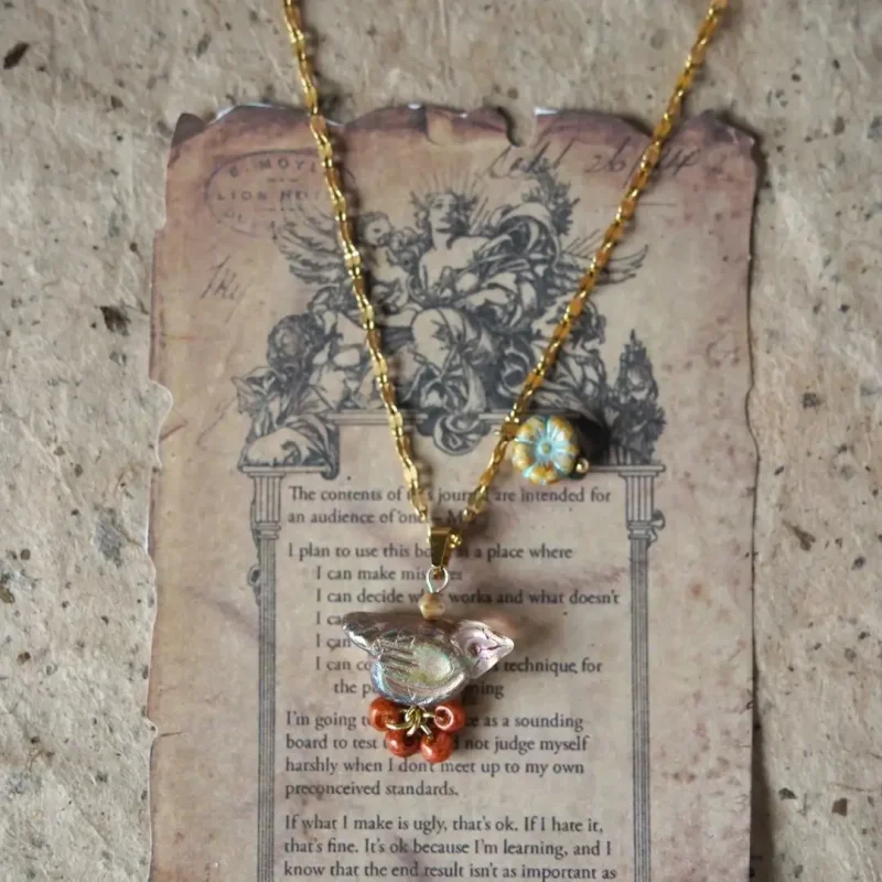 Handmade glass bead necklace highlights layered boho style with vibrant vintage charm.