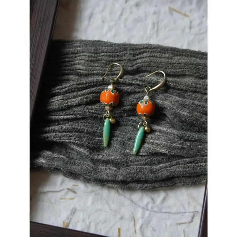 Handmade green drop earrings add natural charm to warm-toned outfits and daily office wear.