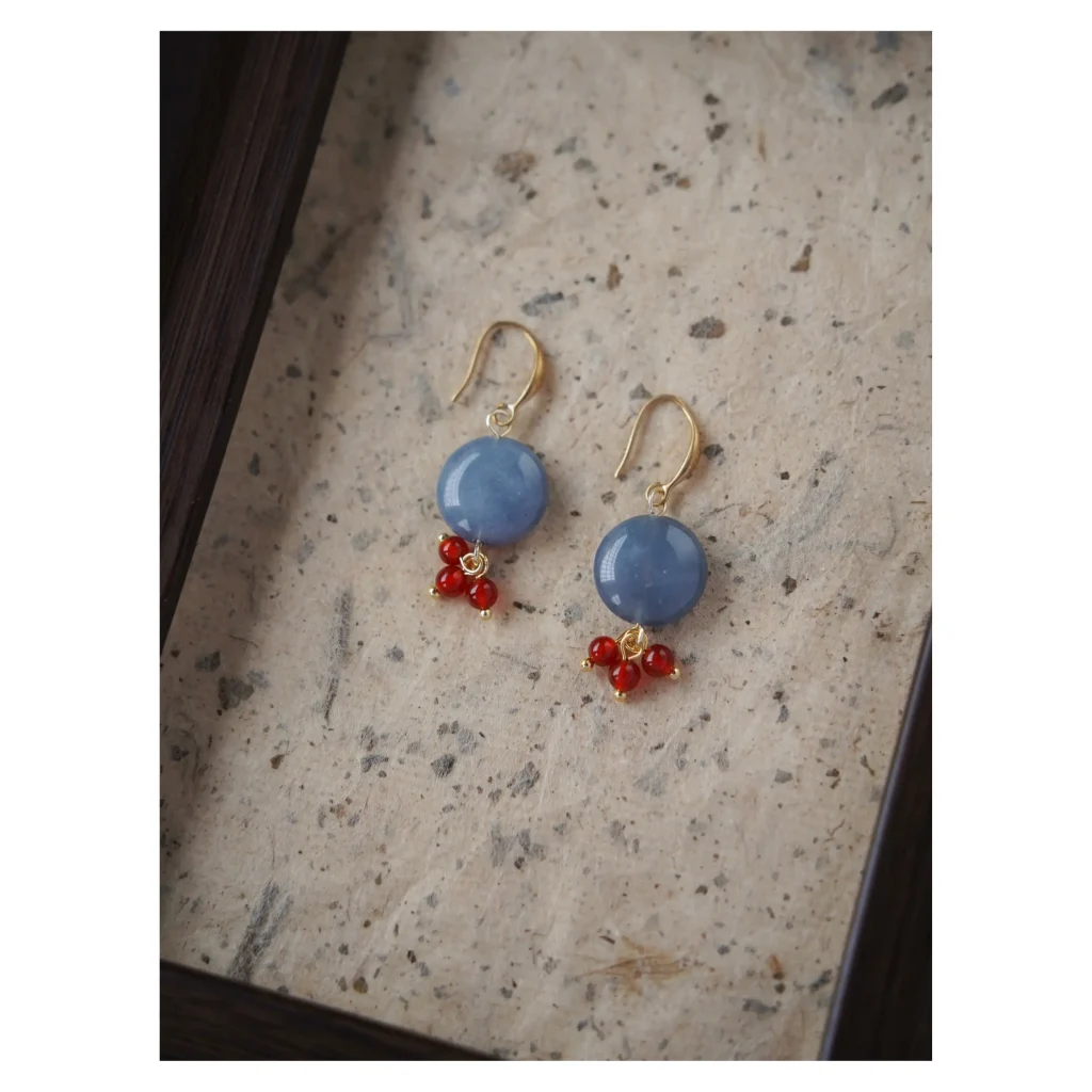 Handcrafted blue chalcedony earrings pair beautifully with red agate to reflect vintage charm and bold femininity.