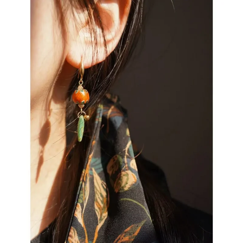 Model showcases handmade vintage glass earrings from Peonyjewels, highlighting artistic charm and retro design.