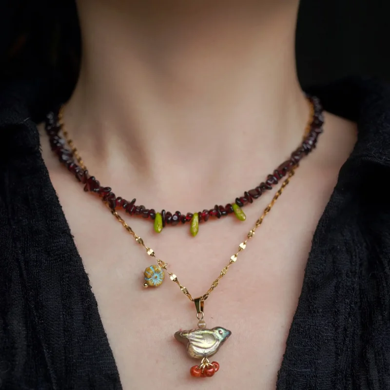 The model layers handmade necklaces with elegance, showing how natural stones and vintage details elevate daily styling.