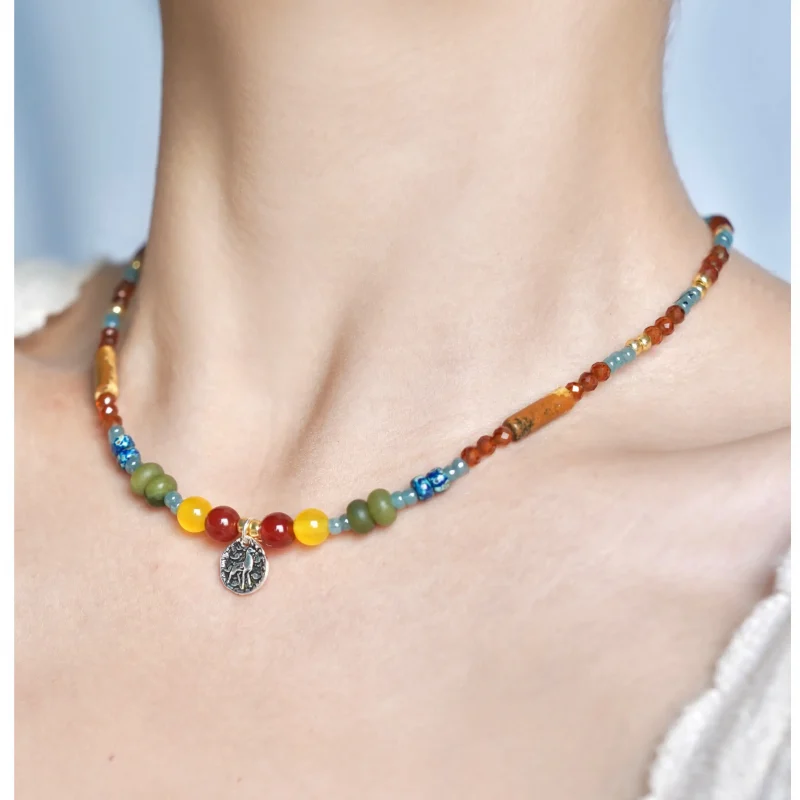 Model wearing the garnet handmade necklace, showcasing rich colors and exquisite craftsmanship.