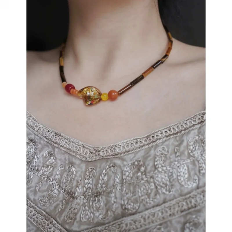 This vintage necklace features tiger’s eye and handmade elements for elegant everyday styling.