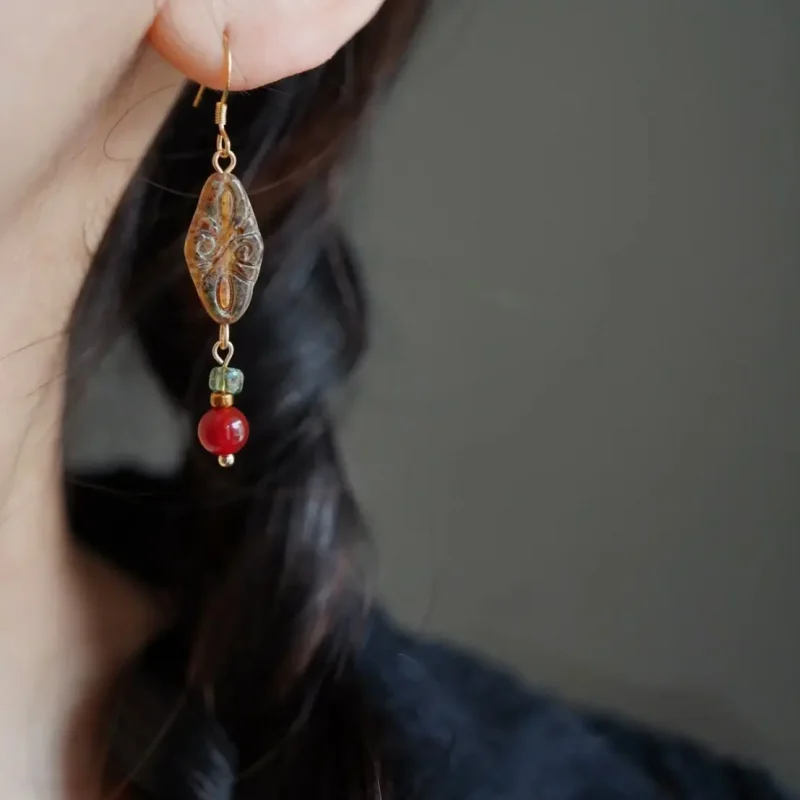 Model wears handcrafted Czech bead earrings to express vintage bohemian charm
