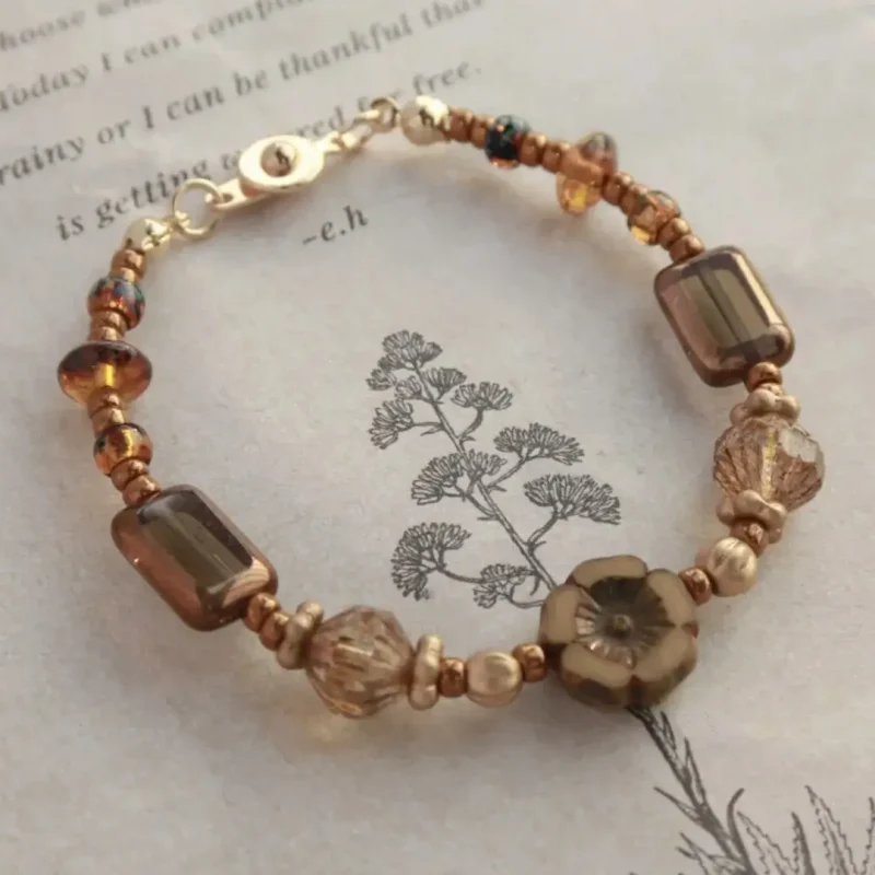 Coffee-tone beaded bracelet features vintage Czech beads for a handcrafted accessory perfect across all seasons.