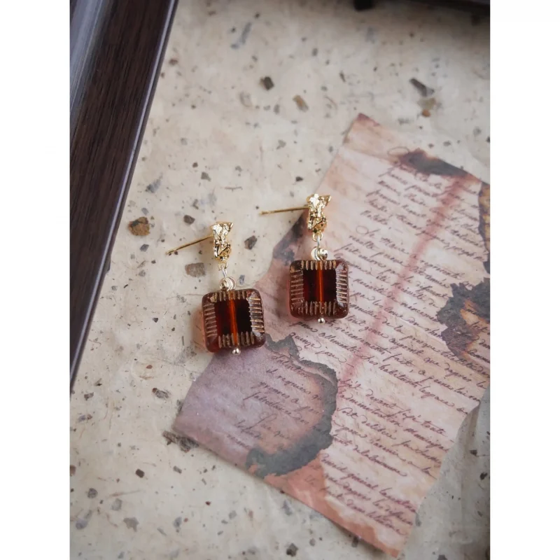 Handcrafted glass earrings feature gold-plated 925 silver posts for elegant everyday wear.