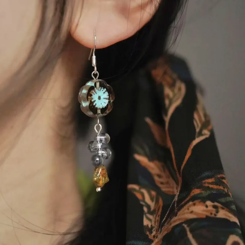 Model showcases handmade vintage Czech glass earrings, adding retro charm to everyday styling.