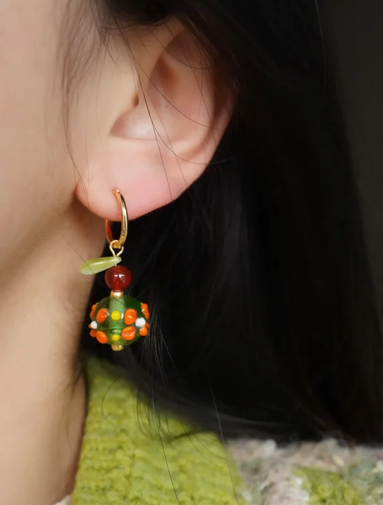 Model wearing earrings, showing elegant daily wear style with artistic handcrafted details.