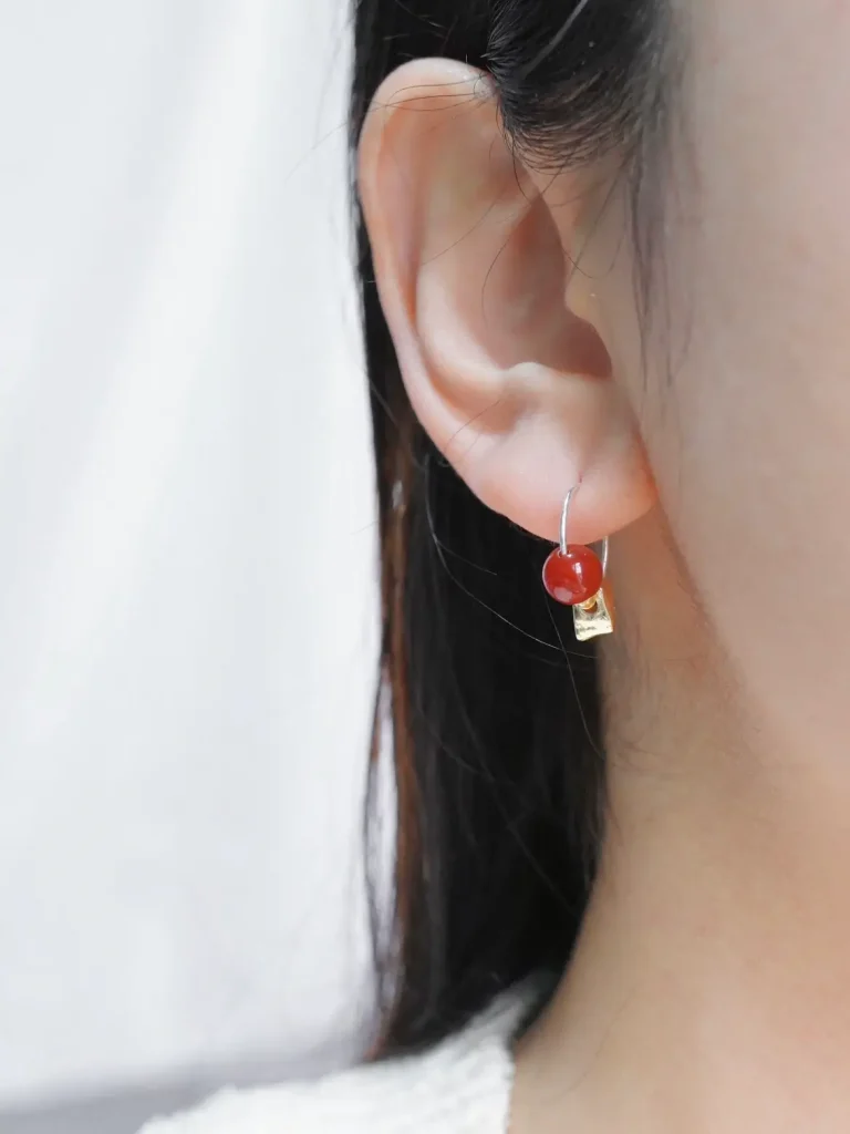 Model wearing silver hoop earrings, showcasing the exquisite charm of handmade jewelry.