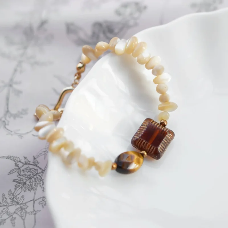 Handmade beaded bracelet with tiger’s eye and antique glass beads shows vintage character and natural elegance.