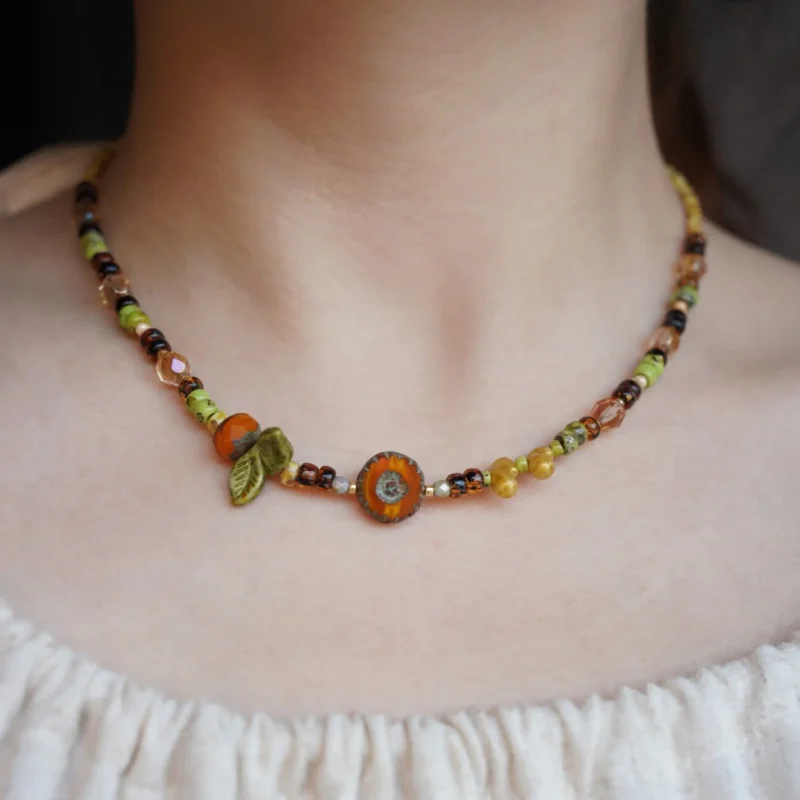Model wears handmade vintage necklace that captures the natural charm of summer