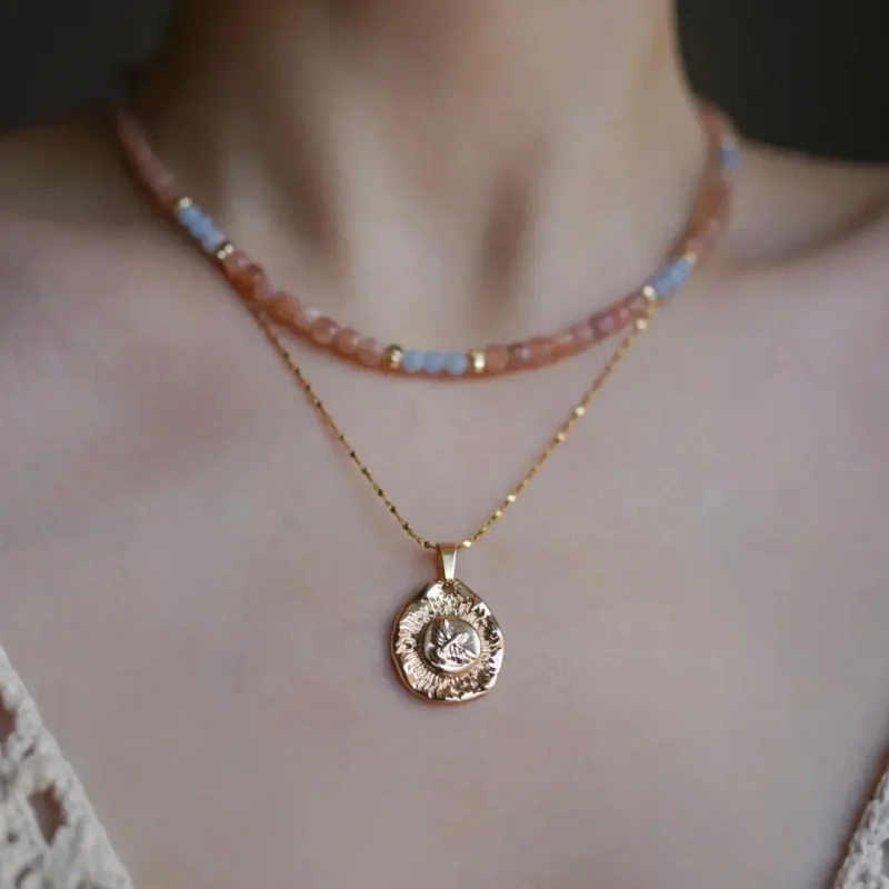 Model wearing handmade vintage layered necklace set with gemstone accents