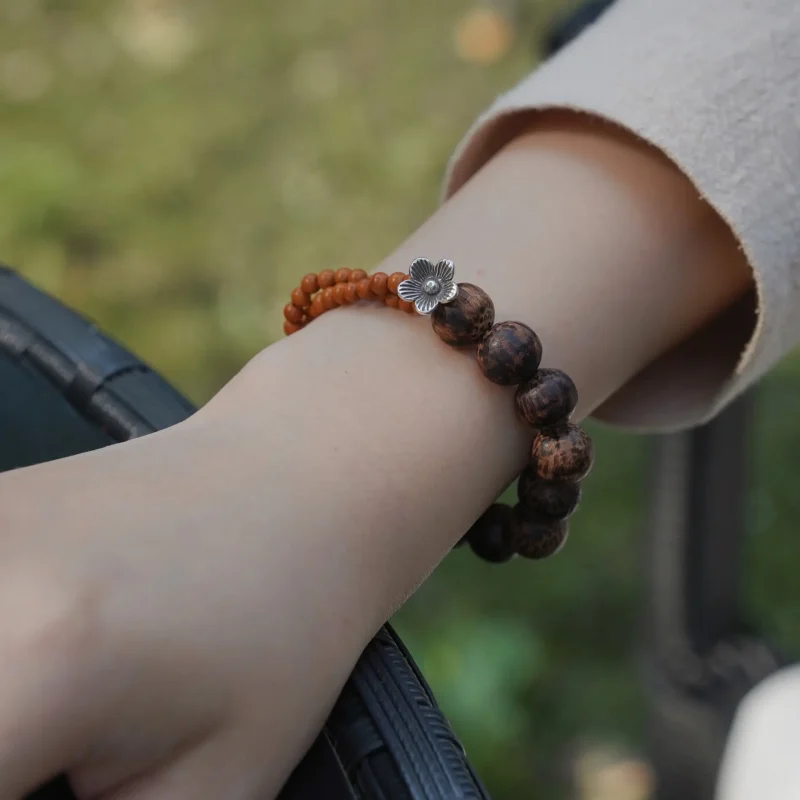 Wearing a handmade wooden bead bracelet showcases the natural beauty and traditional craftsmanship behind each piece