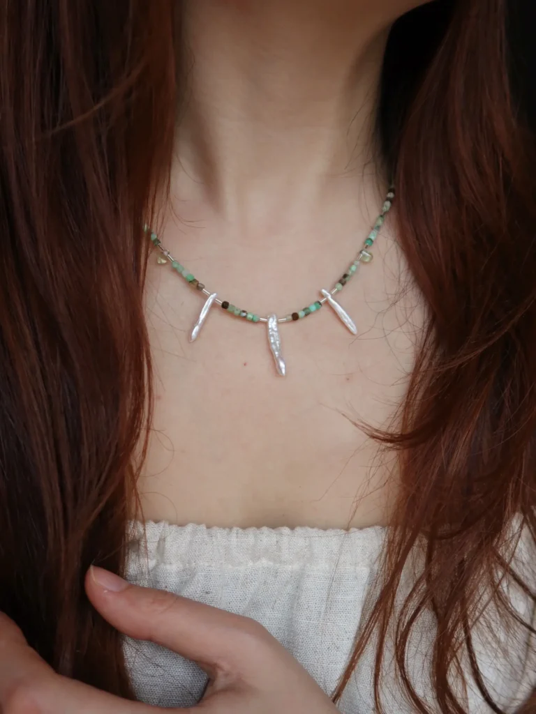 Model wears a unique handcrafted pearl necklace that highlights vintage beauty and timeless elegance