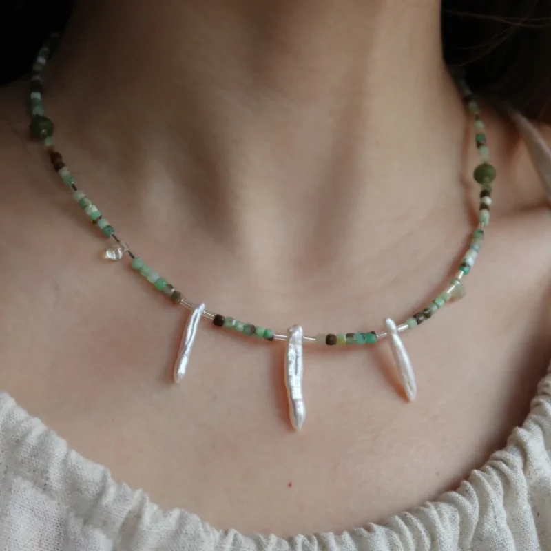 Model wears a handcrafted jade necklace that showcases vintage elegance and timeless charm