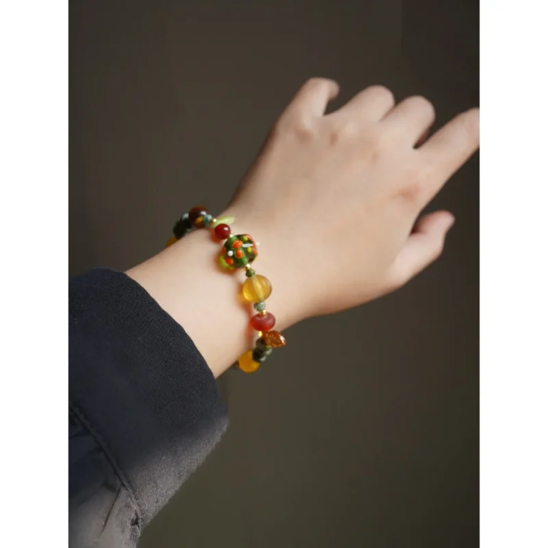 Model wearing a vintage-style handcrafted gemstone bracelet, highlighting feminine charm and artisanal beauty