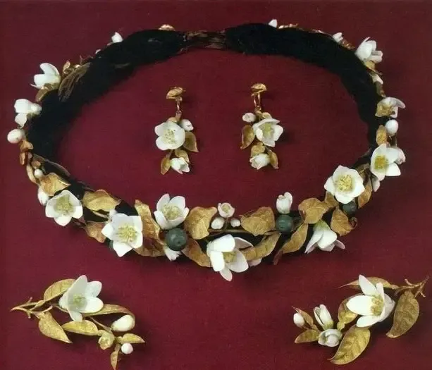 An illustration of a floral crown design, featuring delicate plant motifs like ivy, berries, and flowers, typical of the Romantic Period jewelry.