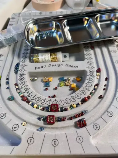Jewelry design board with PeonyJewels necklace on workstation