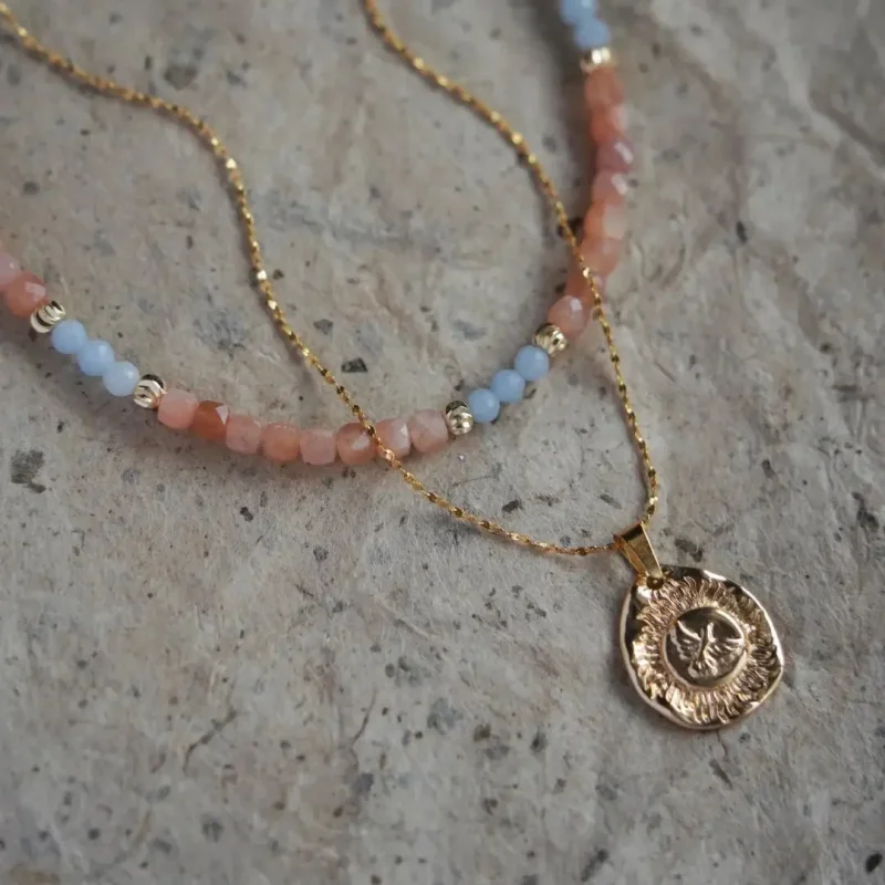 Pink sunstone beaded necklace with blue angel accents in vintage style