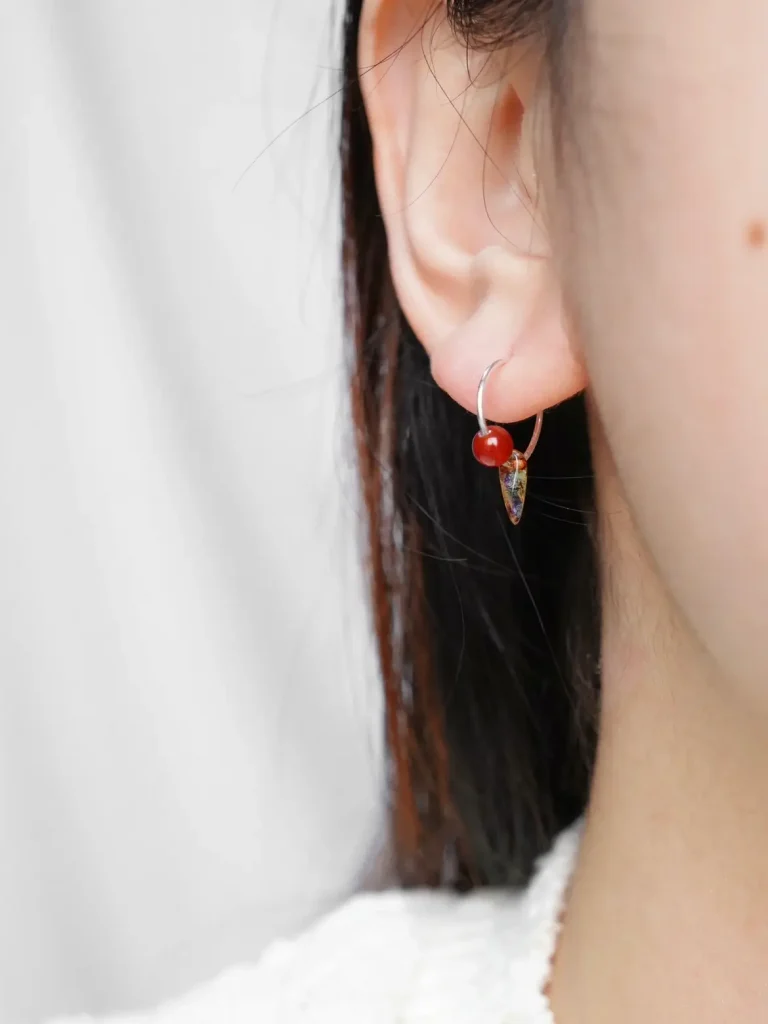 Model wearing red agate hoop earrings, showcasing simple and exquisite charm.