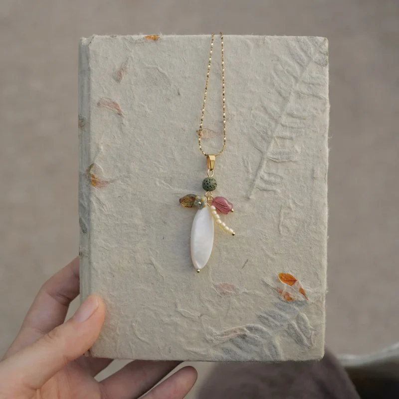 Handmade freshwater pearl necklace pairs with volcanic stones, creating a minimalist, natural style perfect for modern casual wear.