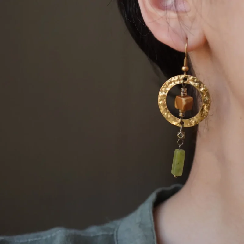 Handcrafted copper earrings displayed in a lifestyle setting, showing their elegant design and everyday wear appeal.