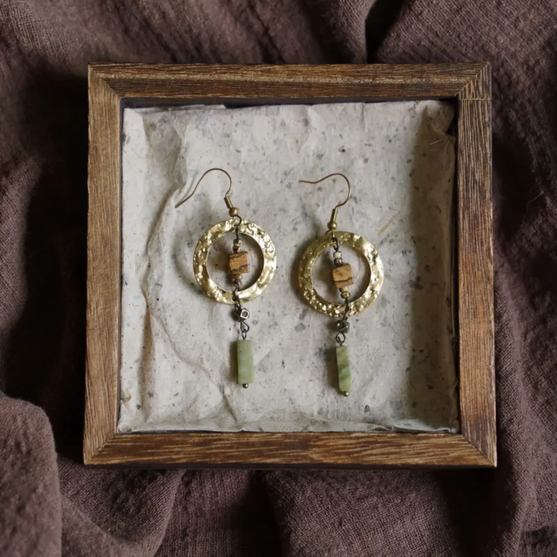 Unique handcrafted round copper earrings with hammered texture, perfect for adding elegance to a friend’s gathering outfit.