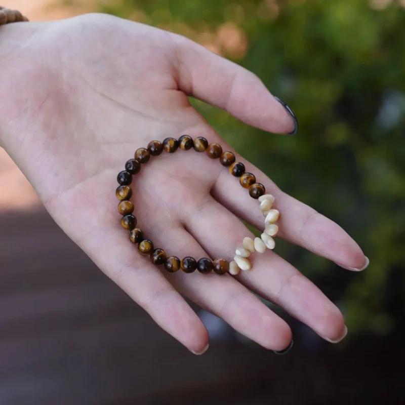 Delicate handmade bracelet resting in hand, showcasing its natural textures and intricate craftsmanship.