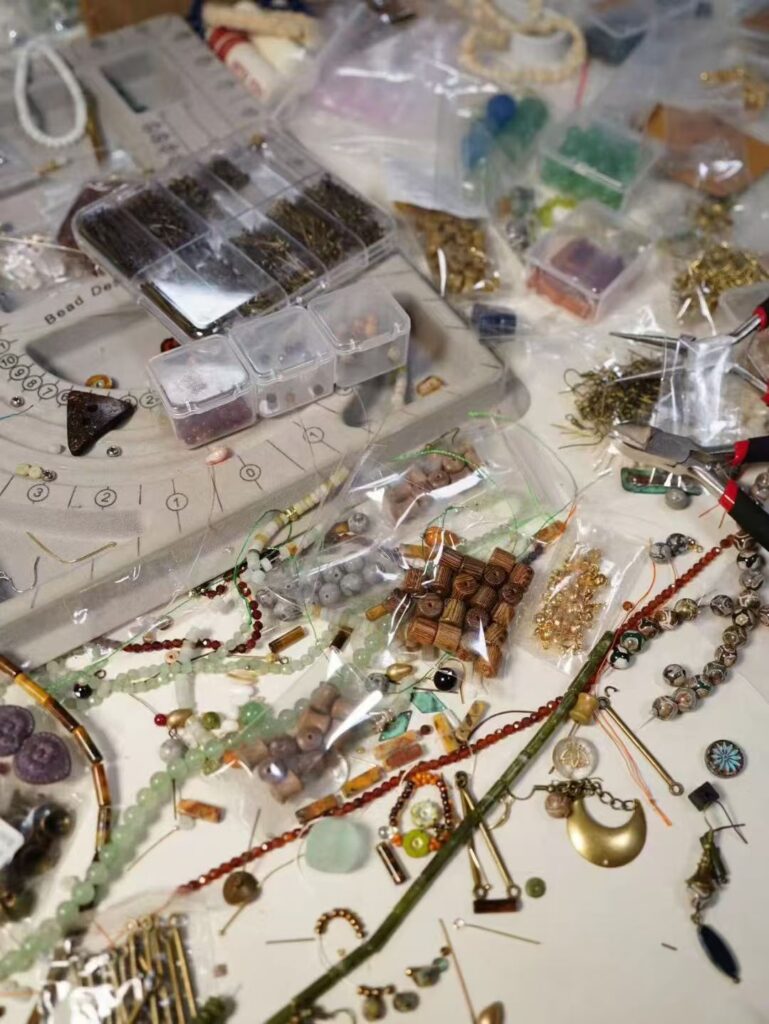 PeonyJewels worktable with scattered beads for handmade vintage jewelry