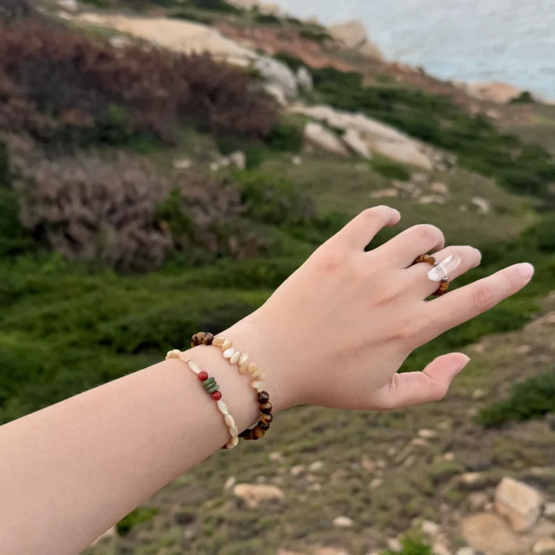 Two distinct beaded bracelets layered together, showcased in natural outdoor light for a stylish and vibrant look.