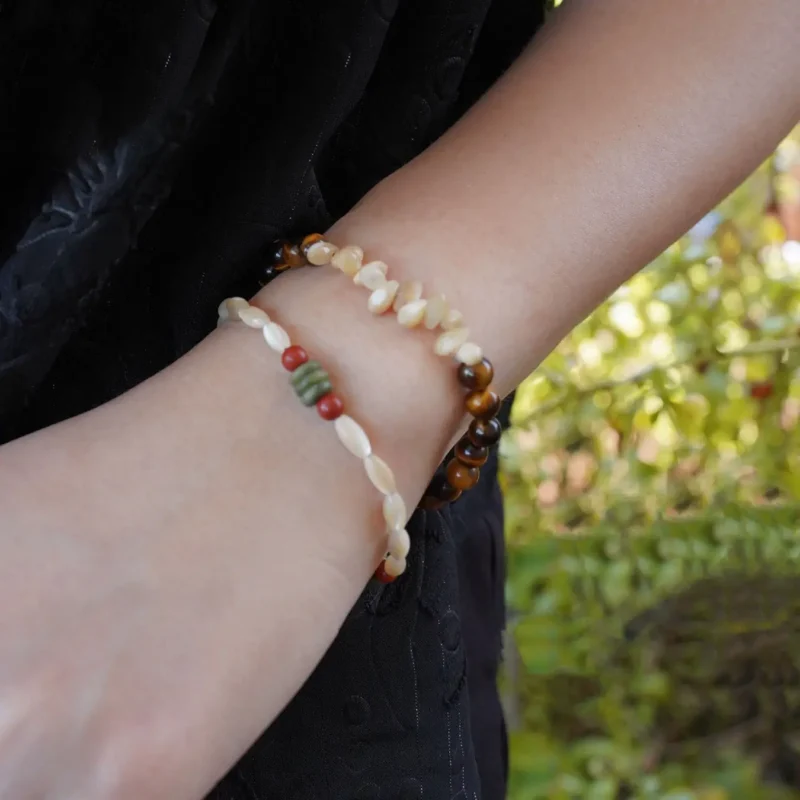 Close-up of handmade bracelets layered together, highlighting intricate details and artisanal craftsmanship