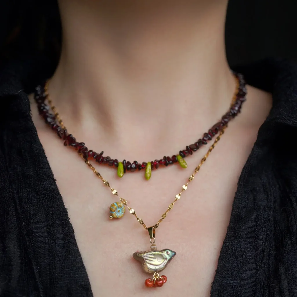 Pair the thorn bird pendant with a garnet bead necklace.