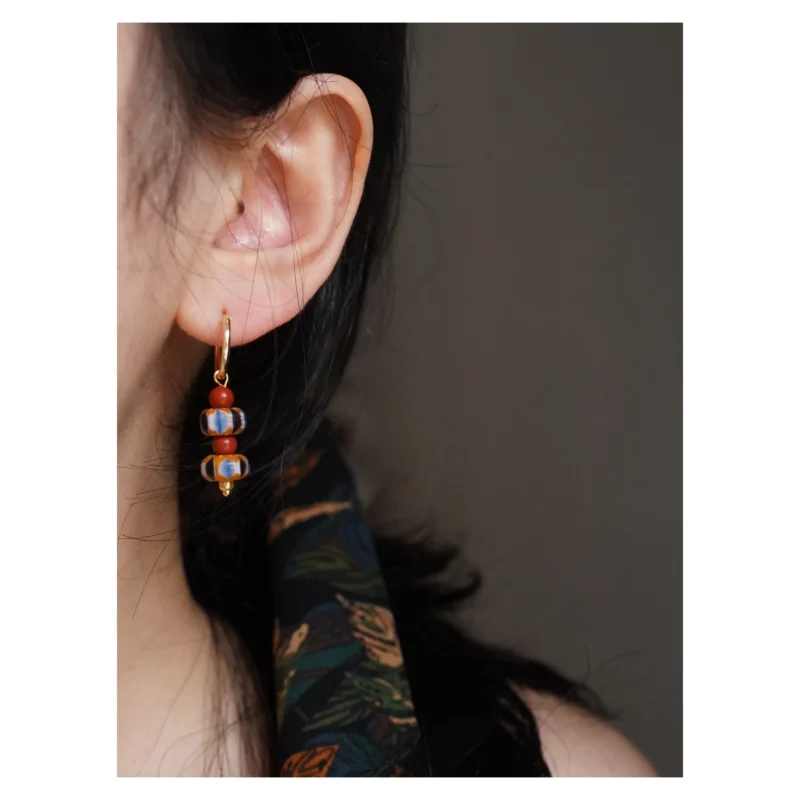 Vintage glass hoop earrings worn by model highlight handcrafted artistry and elegant design, perfect for stylish everyday wear.