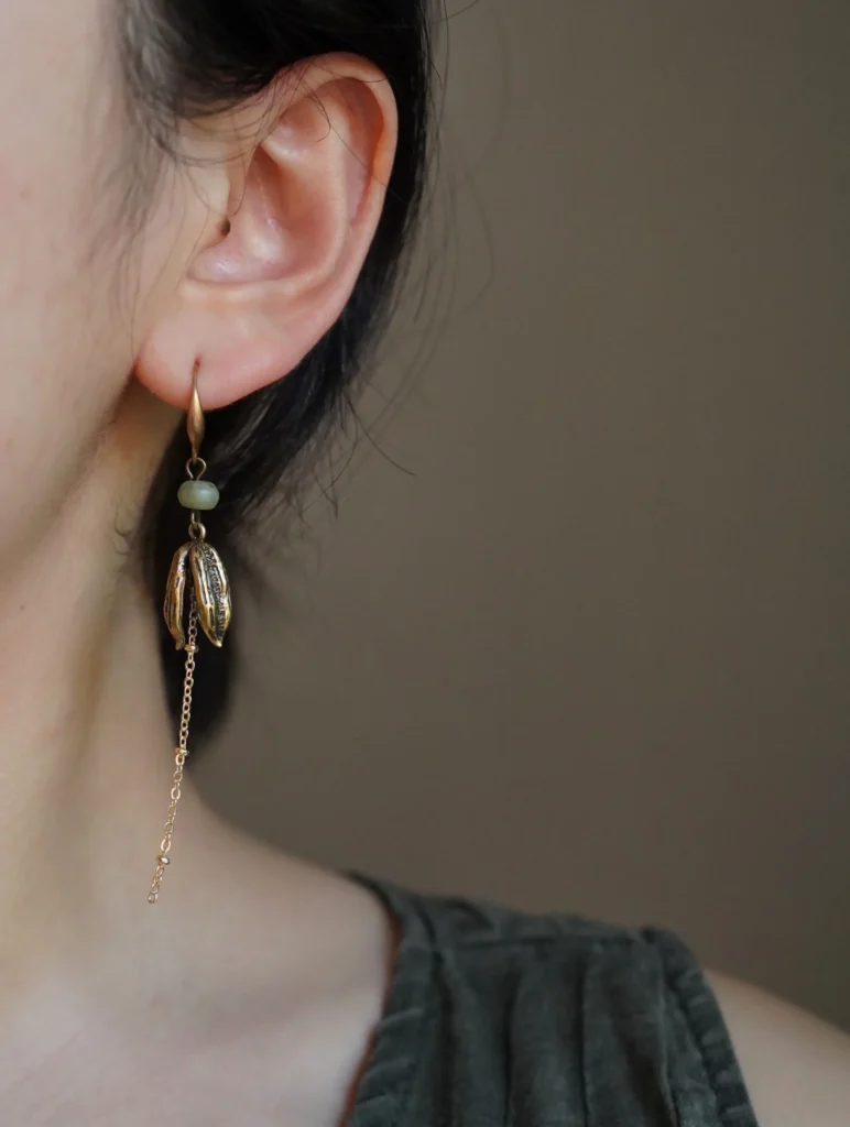 Handmade vintage silver earrings showcased by model, highlighting elegant craftsmanship and timeless style for women.