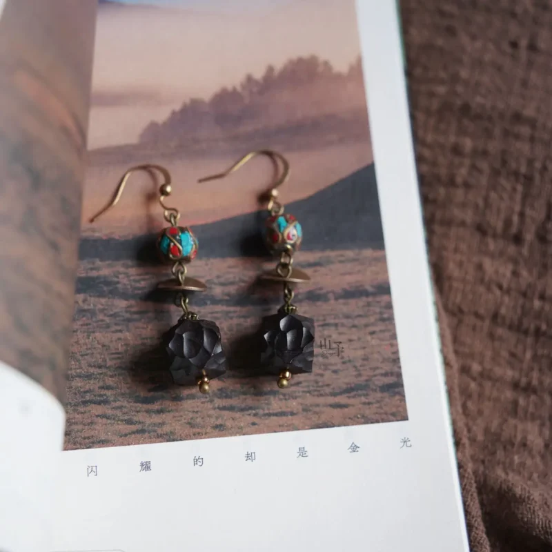 Handcrafted natural ebony wood pendant earrings showcase a unique Tibetan-inspired vintage style for women.