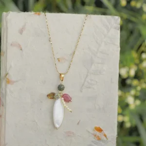 Handmade steel-titanium pendant necklace showcases natural elegance with freshwater pearls, Czech beads, and volcanic stones.