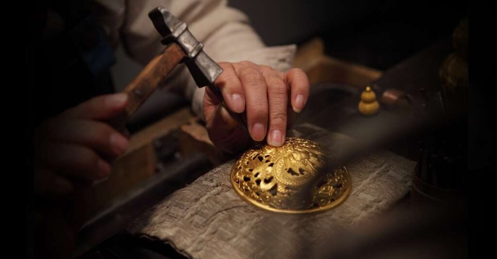Artisan shaping metal with hammer and chasing, demonstrating Jewelry Metal Texturing Techniques