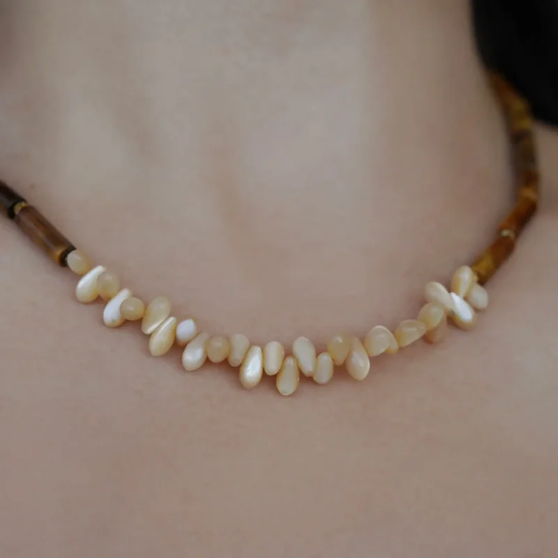 This handcrafted beaded necklace is shown worn, highlighting its design, texture, and versatile everyday style.