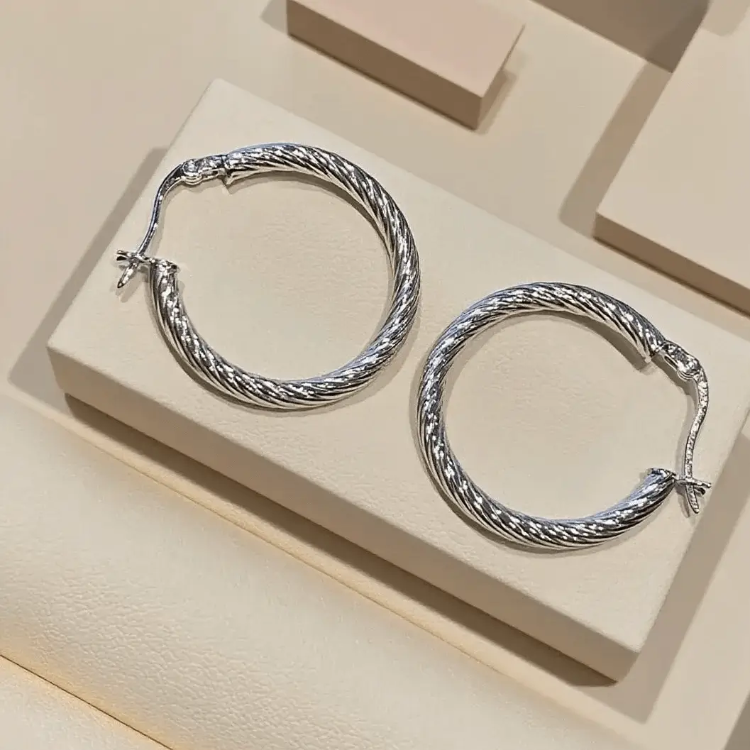 Handmade 925 sterling silver hoops with a classic twisted design, perfect for daily wear.