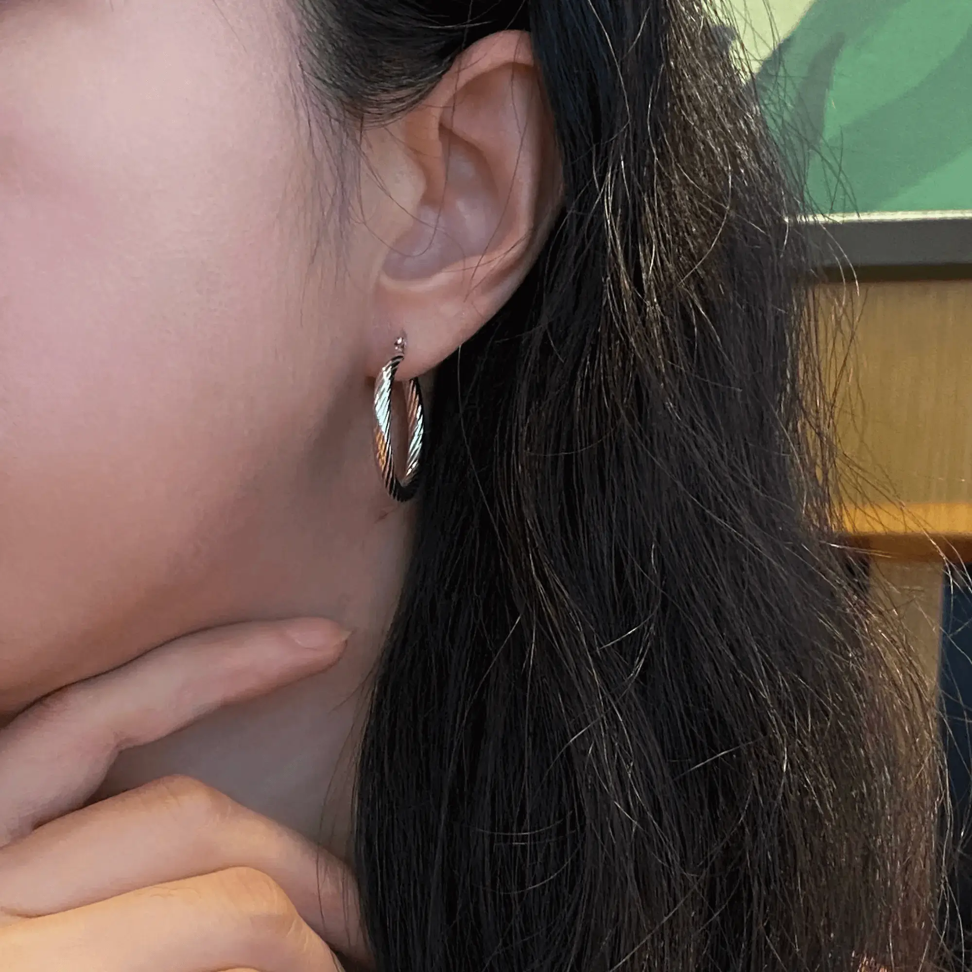 Elegant and subtle hoop earrings, showcasing a refined wearing effect.
