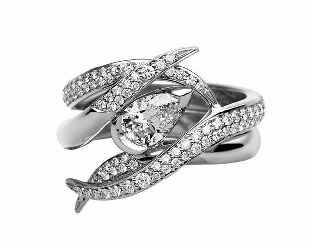 A classic diamond engagement ring, featuring a beautifully cut diamond set in a timeless band, showcasing elegance and sophistication.