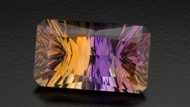 Fancy-cut ametrine gemstone showcasing vivid purple and yellow zones, highlighting its color zoning and clarity.