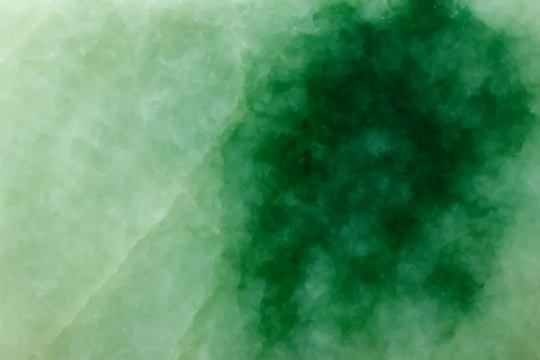 Close-up of jadeite showing huadi color variations affecting its quality